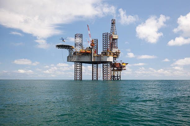 Offshore jack-up drilling rig in turquoise coastal water