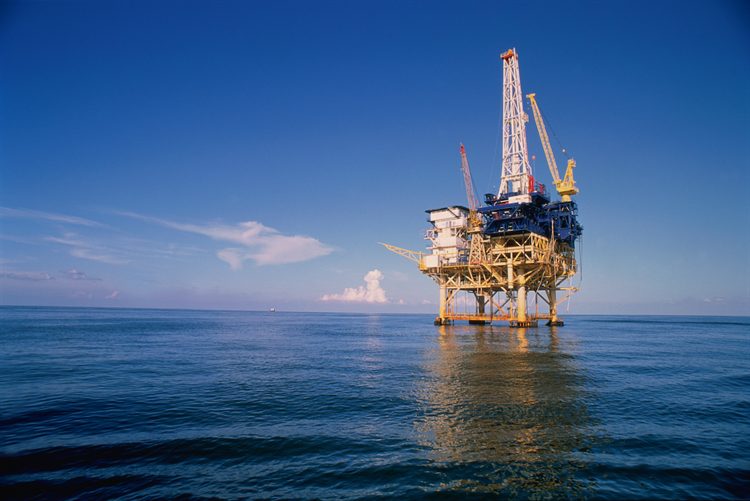 Offshore oil platform in the Gulf of Mexico with a helicopter approaching