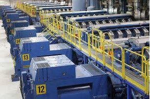 Rows of blue turbine generator sets inside an industrial facility